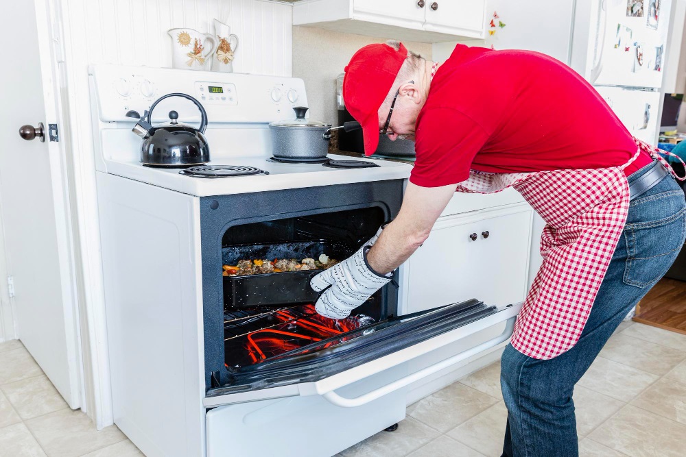 man opening Warming Drawer to Repair